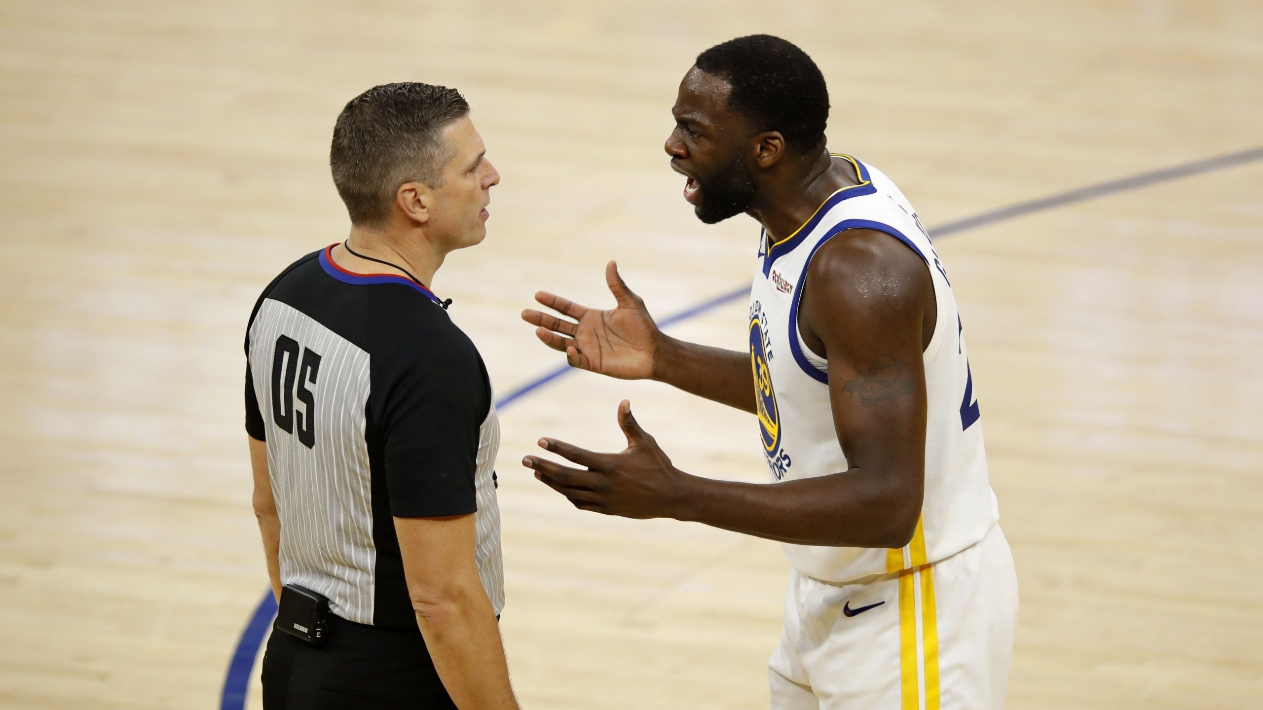 Draymond Green of the Golden State Warriors arguing a call with a referee on the basketball court